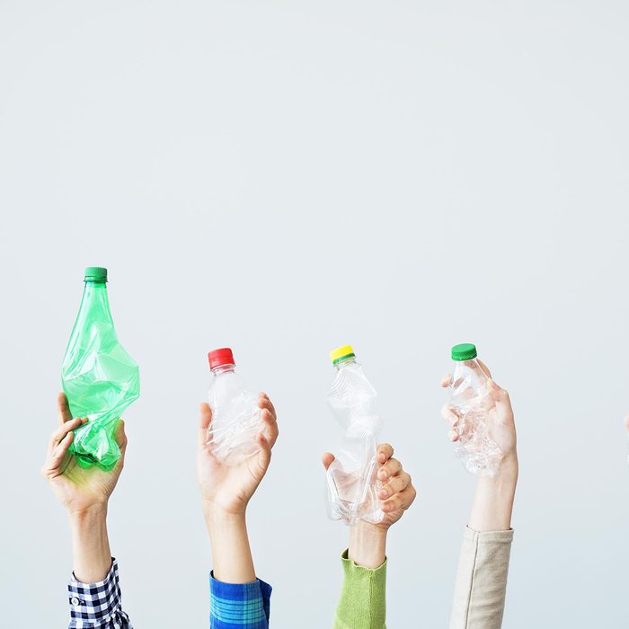 Hands holding up plastic bottles