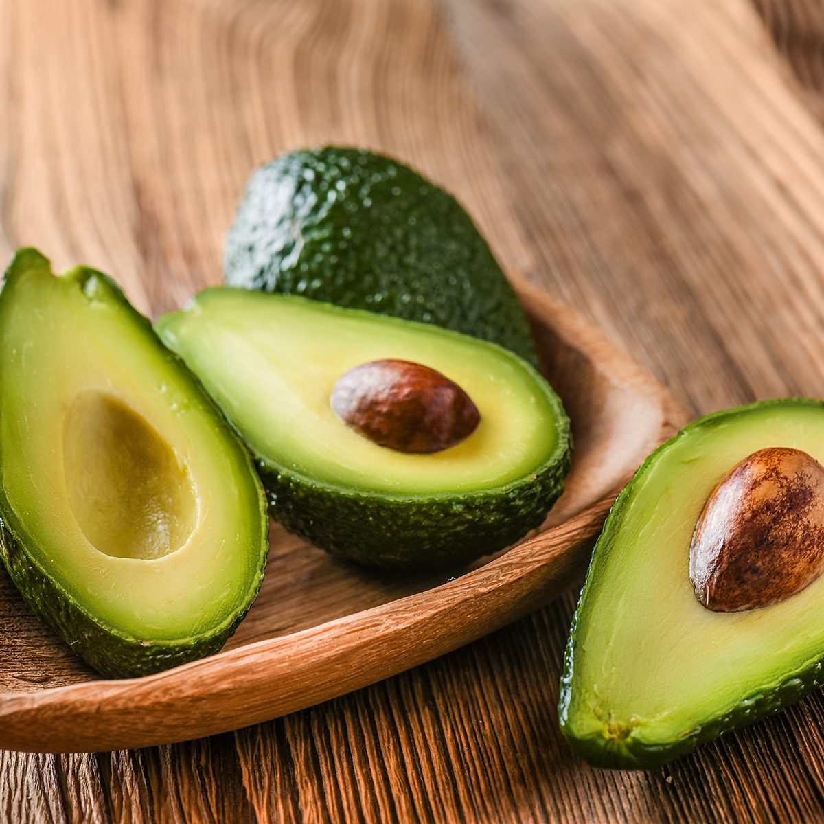 Avocado on old wooden table.