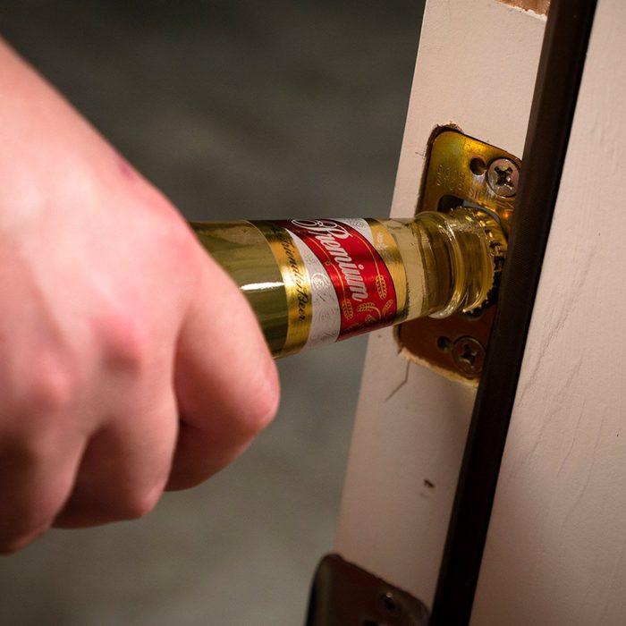 Opening a bottle with a door