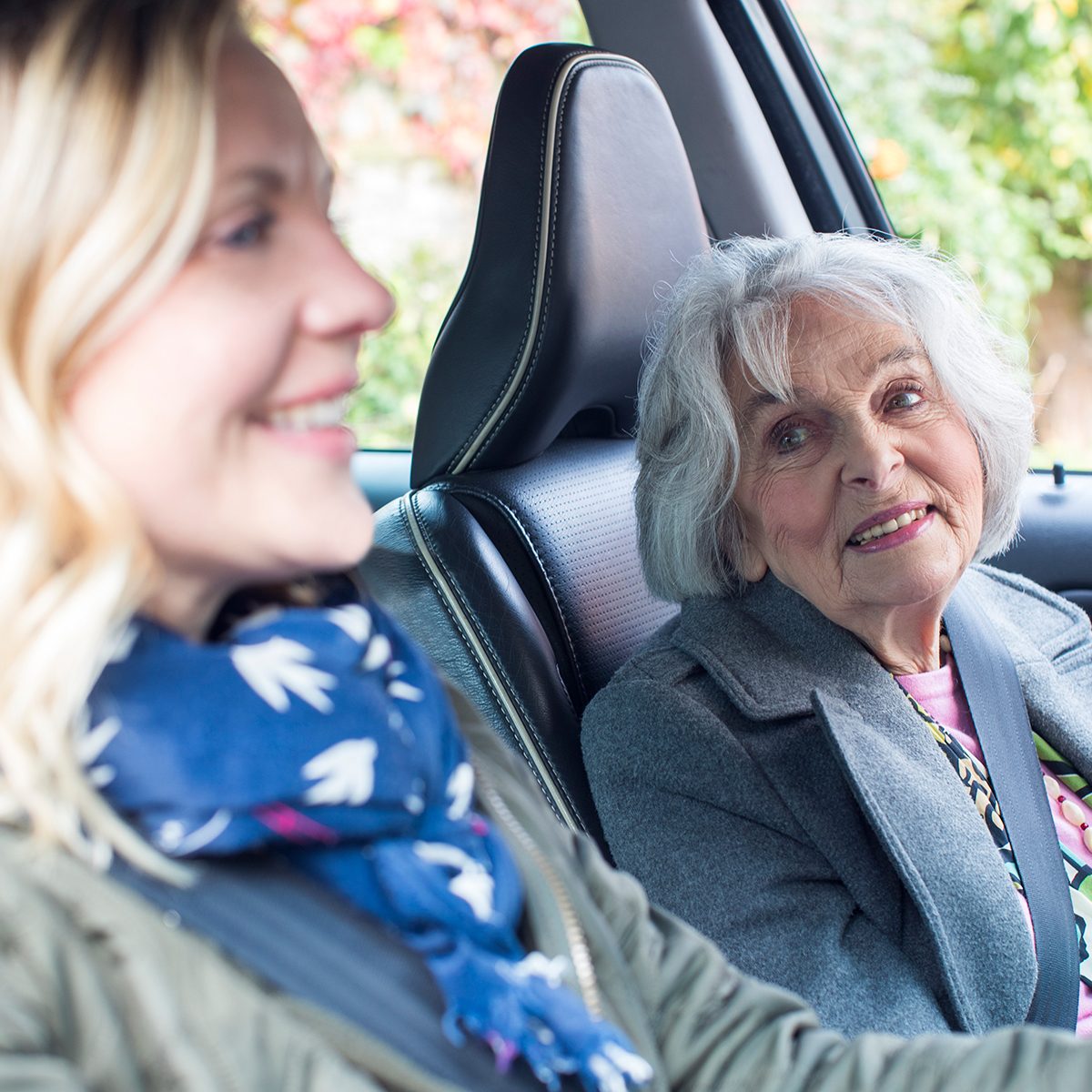 Female Neighbor Giving Senior Woman A Lift In Car