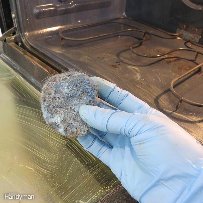 Hand holding dirty sponge