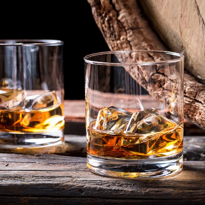 Old and tasty cognac with ice and oak barrel