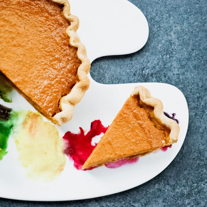 slice of sweet potato pie on a plate that looks like a paint palette