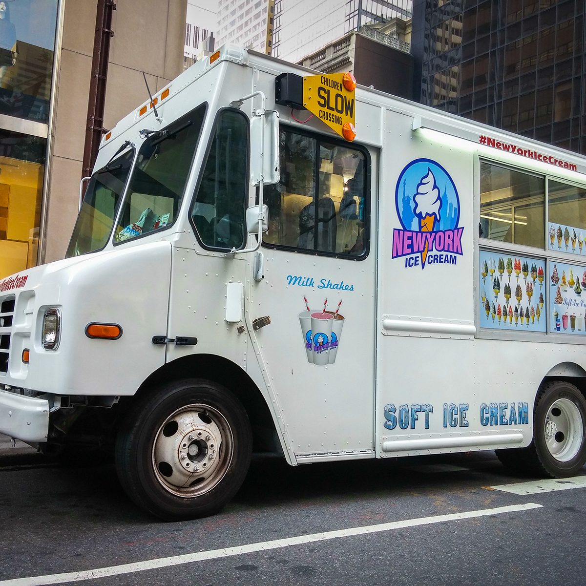 White ice cream truck on a street in New York City - July 1, 2015, 51st street and 5th avenue, New York City, NY, USA