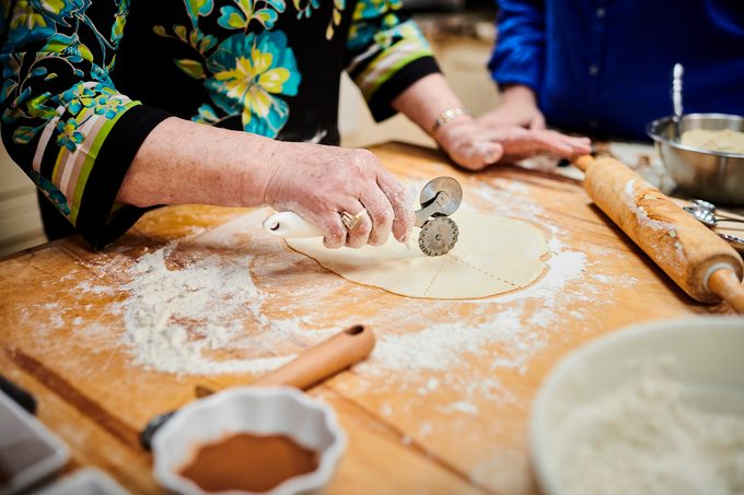woman rolling out dough for homemade cookies