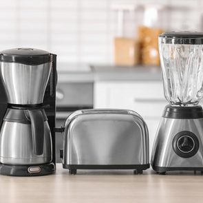 Kitchen appliances on table against blurred background