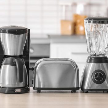 Kitchen appliances on table against blurred background
