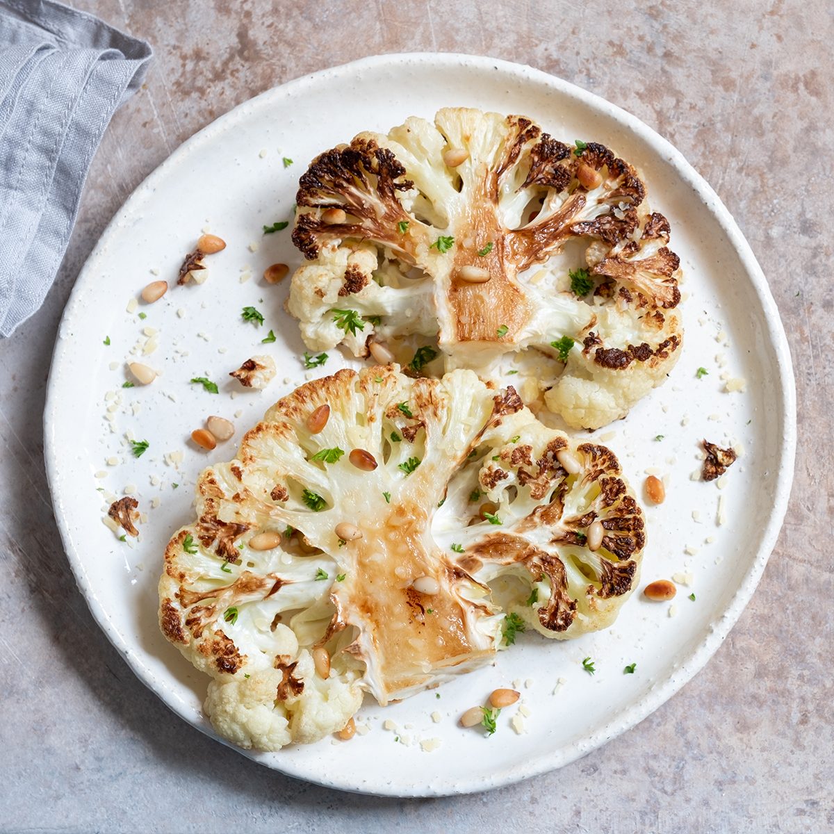 Vegetarian roasted cauliflower steak with pine nuts; Shutterstock ID 1342494923; Job (TFH, TOH, RD, BNB, CWM, CM): TOH