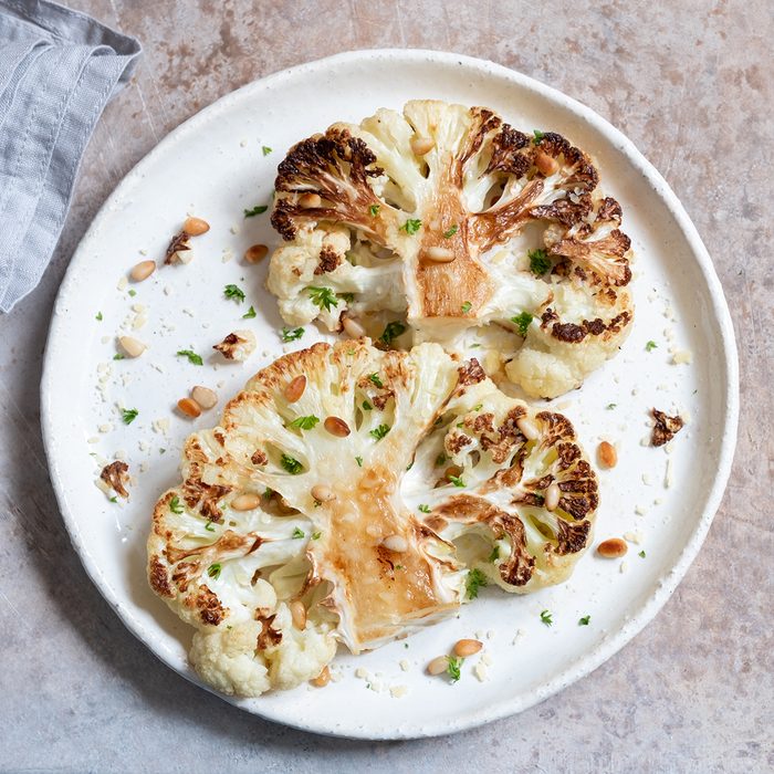 Vegetarian roasted cauliflower steak with pine nuts; Shutterstock ID 1342494923; Job (TFH, TOH, RD, BNB, CWM, CM): TOH