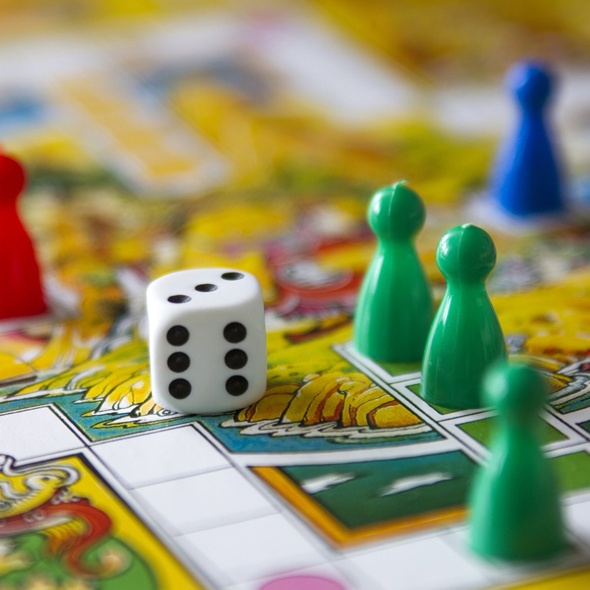 colorful play figures with dice on board