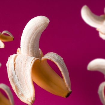 fresh flying bananas pattern on a vibrant pink background