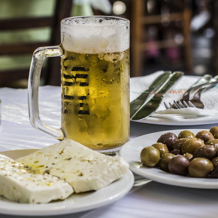 Greek famous food: cheese and olives with a glass of beer on the table, Athens, Greece