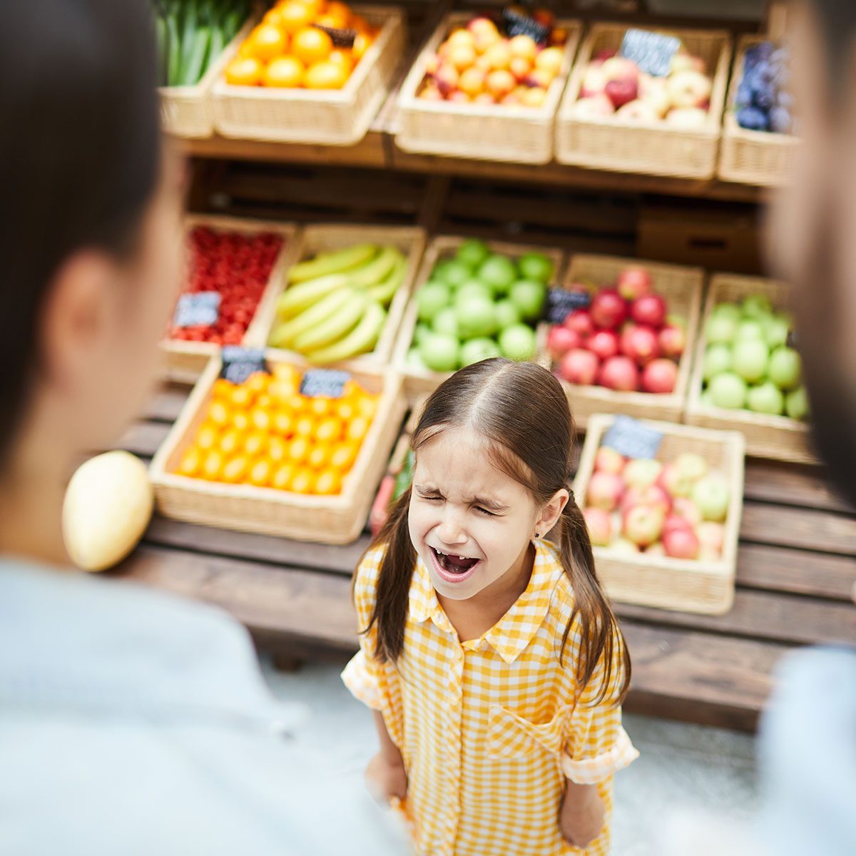 Upset hysterical girl with closed eyes crying loudly while manipulating parents and standing against food stall in supermarket; Shutterstock ID 1220942938; Job (TFH, TOH, RD, BNB, CWM, CM): TOH