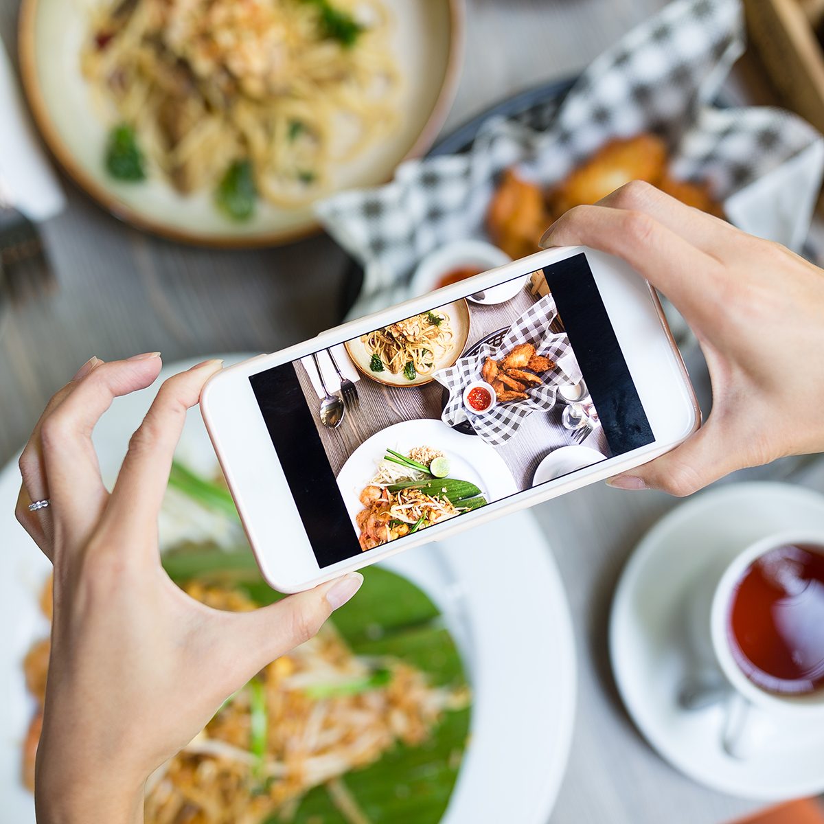 doing it for the gram, 2020 food trends, Woman taking photo on cellphone on dish; Shutterstock ID 593589896; Job (TFH, TOH, RD, BNB, CWM, CM): Taste of Home