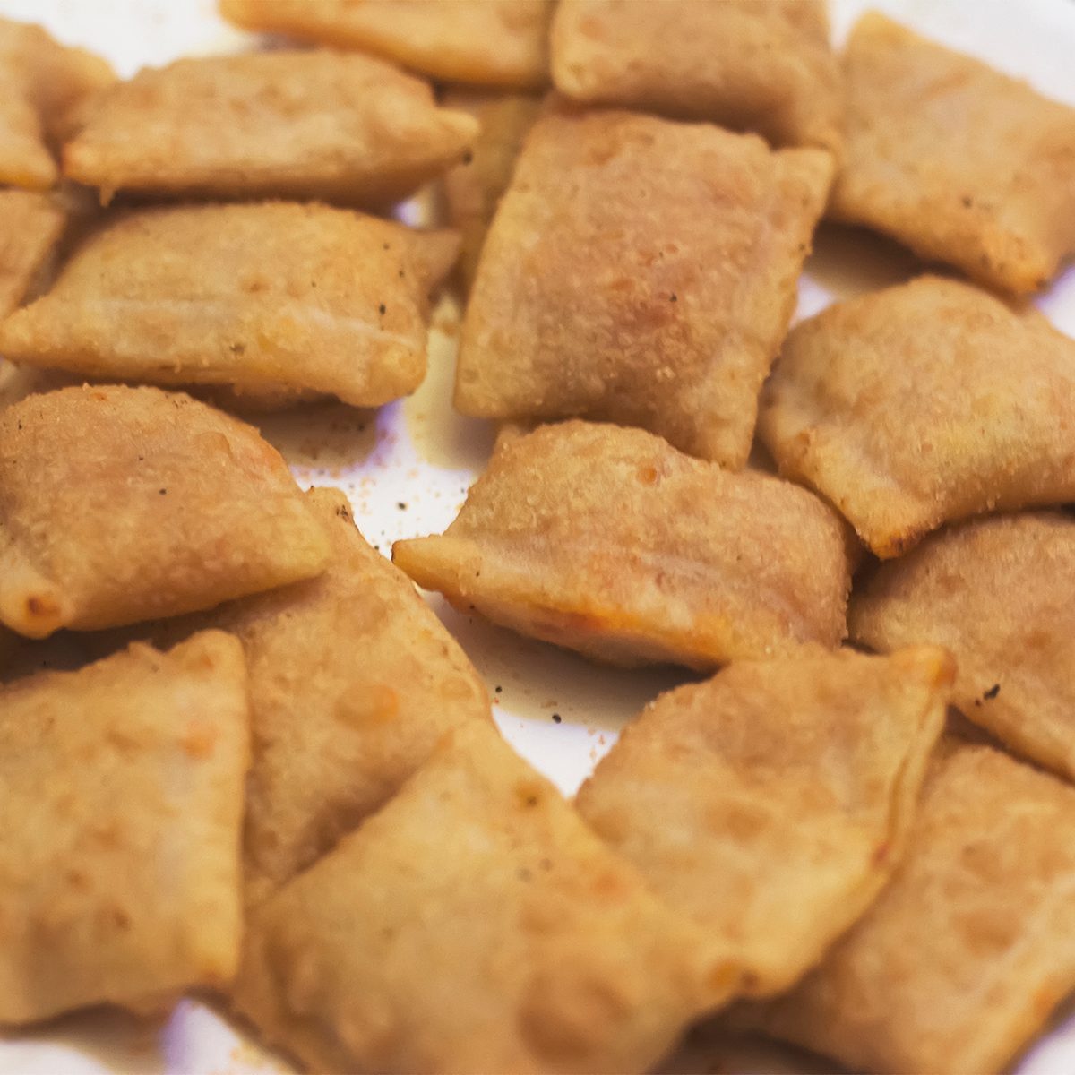 Pizza rolls on a white background at an angled view.