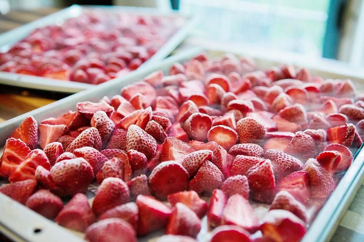 2 sheet pans full of frozen strawberries