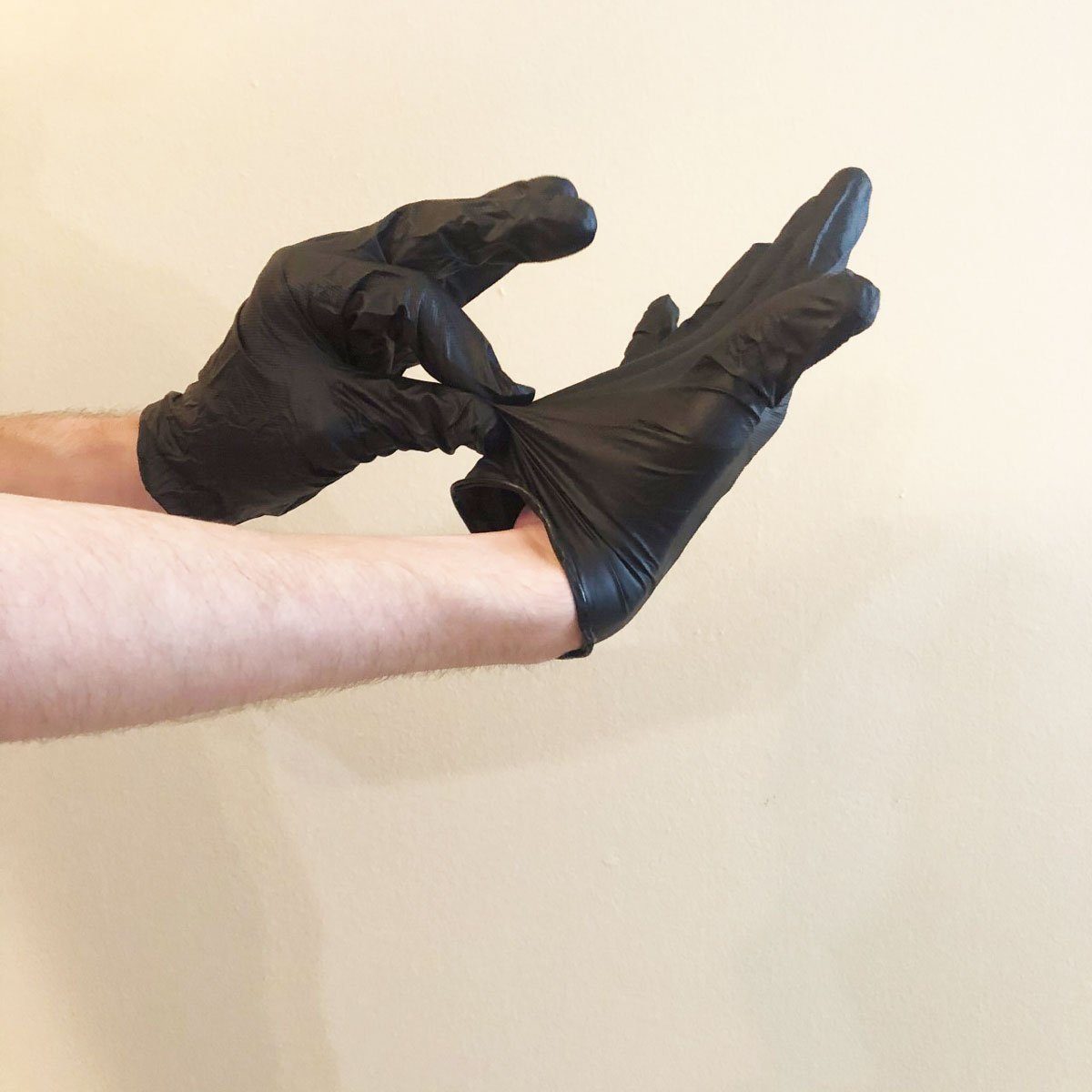 Step 1 of removing nitrile gloves