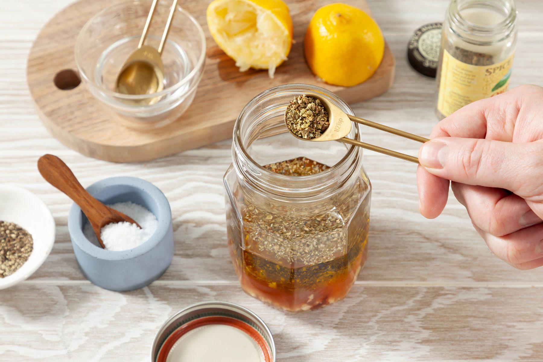 olive oil, red wine vinegar and other ingredients mixed in a jar