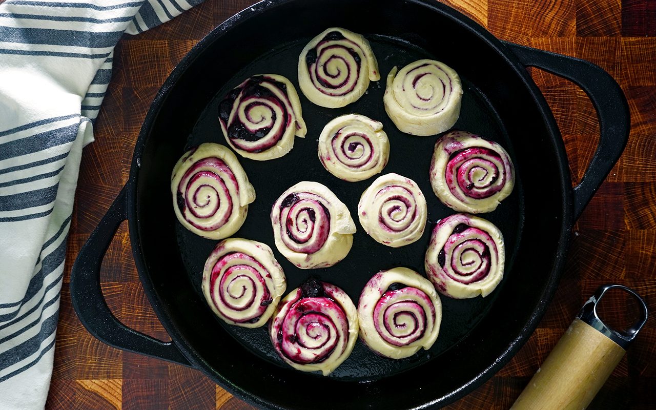 sliced blueberry sweet roll dough ready to be proofed a second time