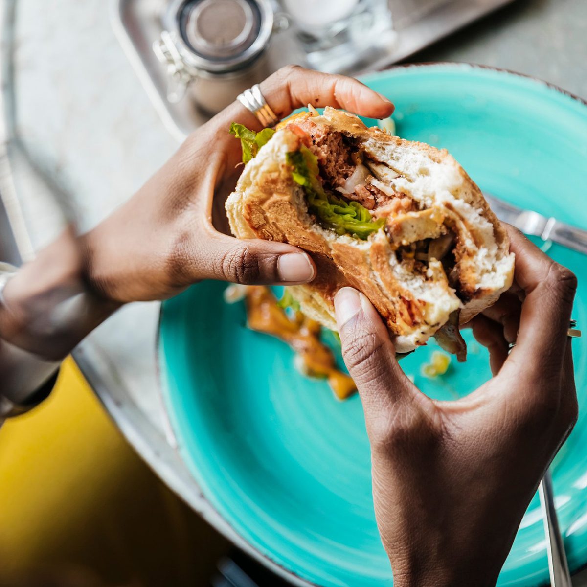Eating burger with hands