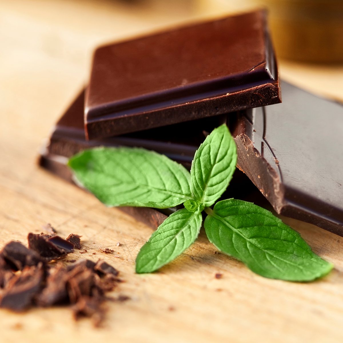 Chocolate and mint on a wooden table. Shallow depth of field.