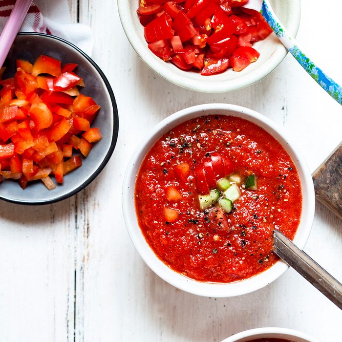 Bowl of Gazpacho with cucumber and bell pepper topping