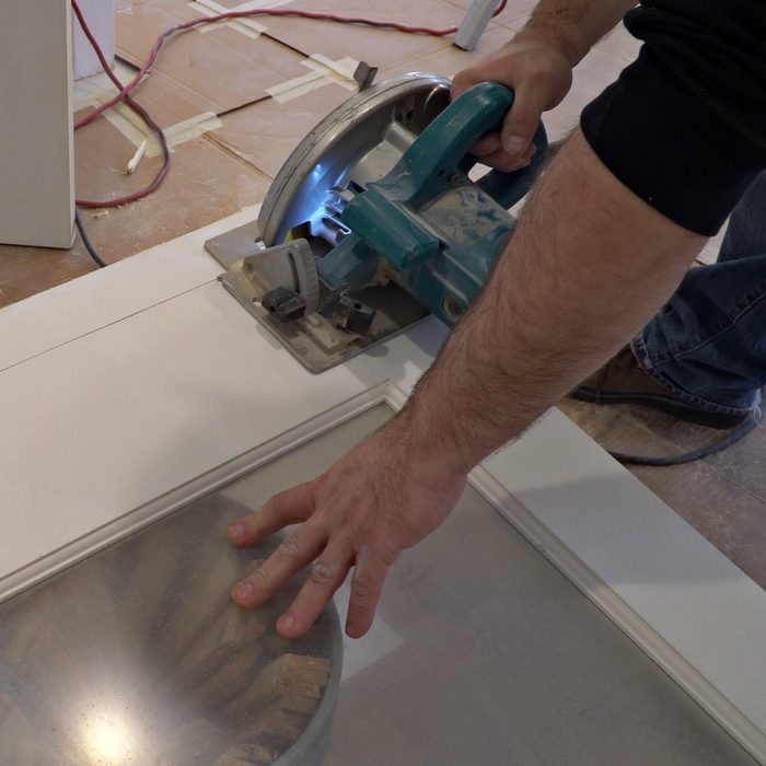 man using a circular saw for cutting wood door construction and home renovation, repair tools