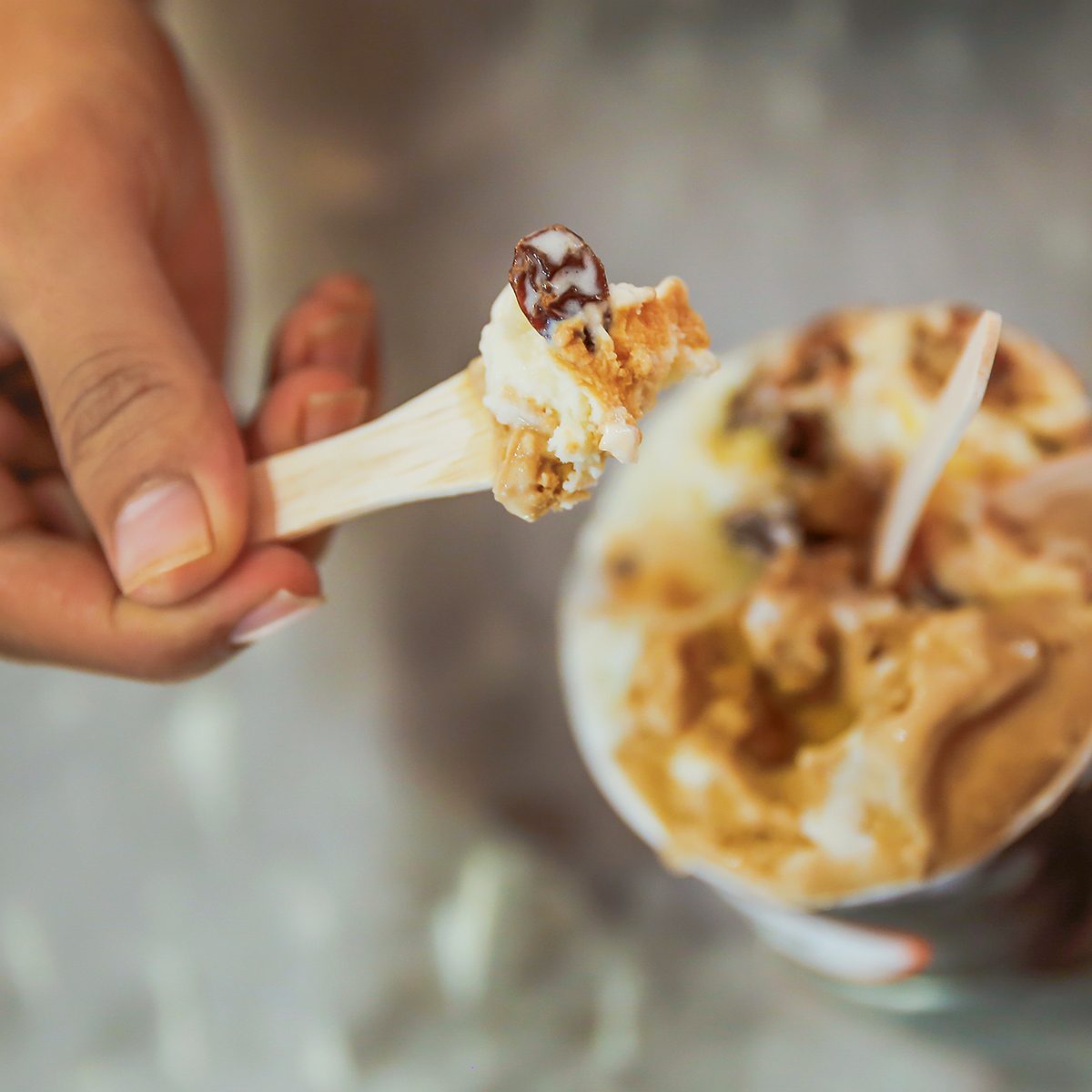 Adult men eating rum raisin ice cream