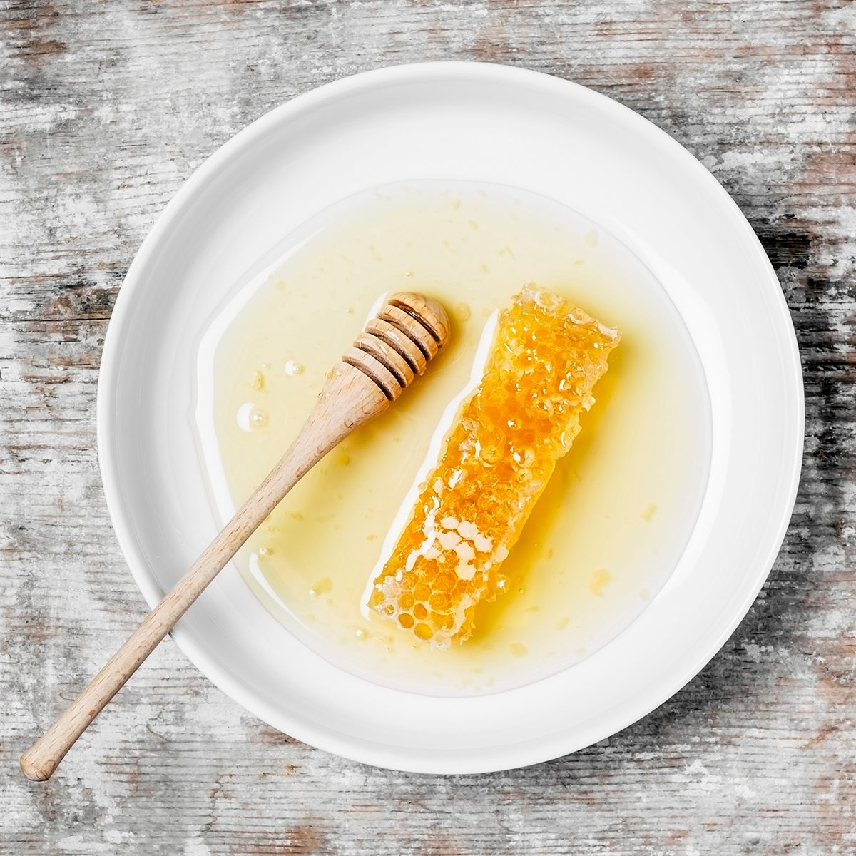 Honeycomb on a plate on wooden background