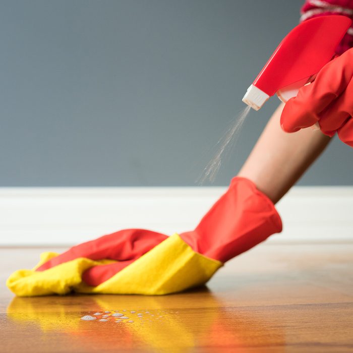 Cleaning parquet with yellow cloth