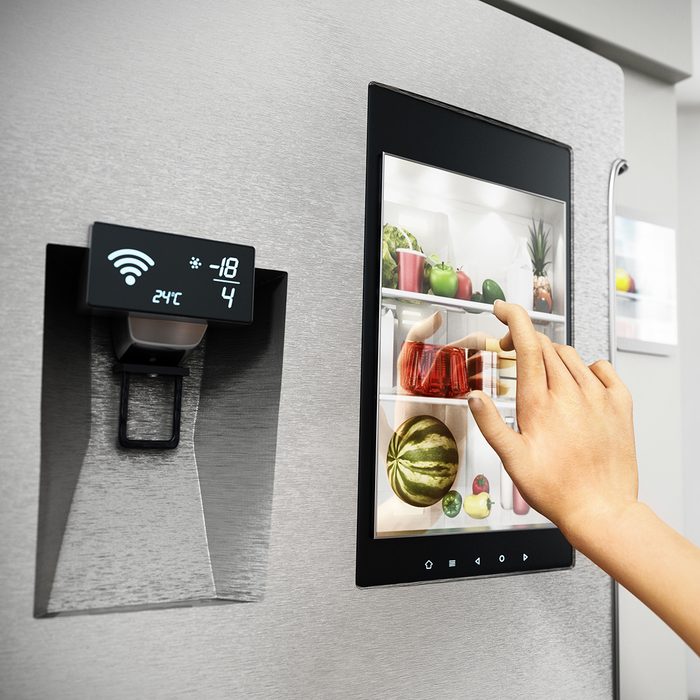 SMART KITCHENS GET SMARTER Food Trends Report, Hand controls smart refrigerator interface with an image of the interior.