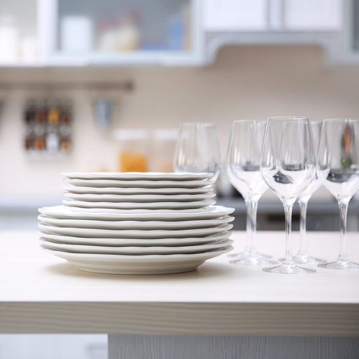 stack of clean plates with glasses