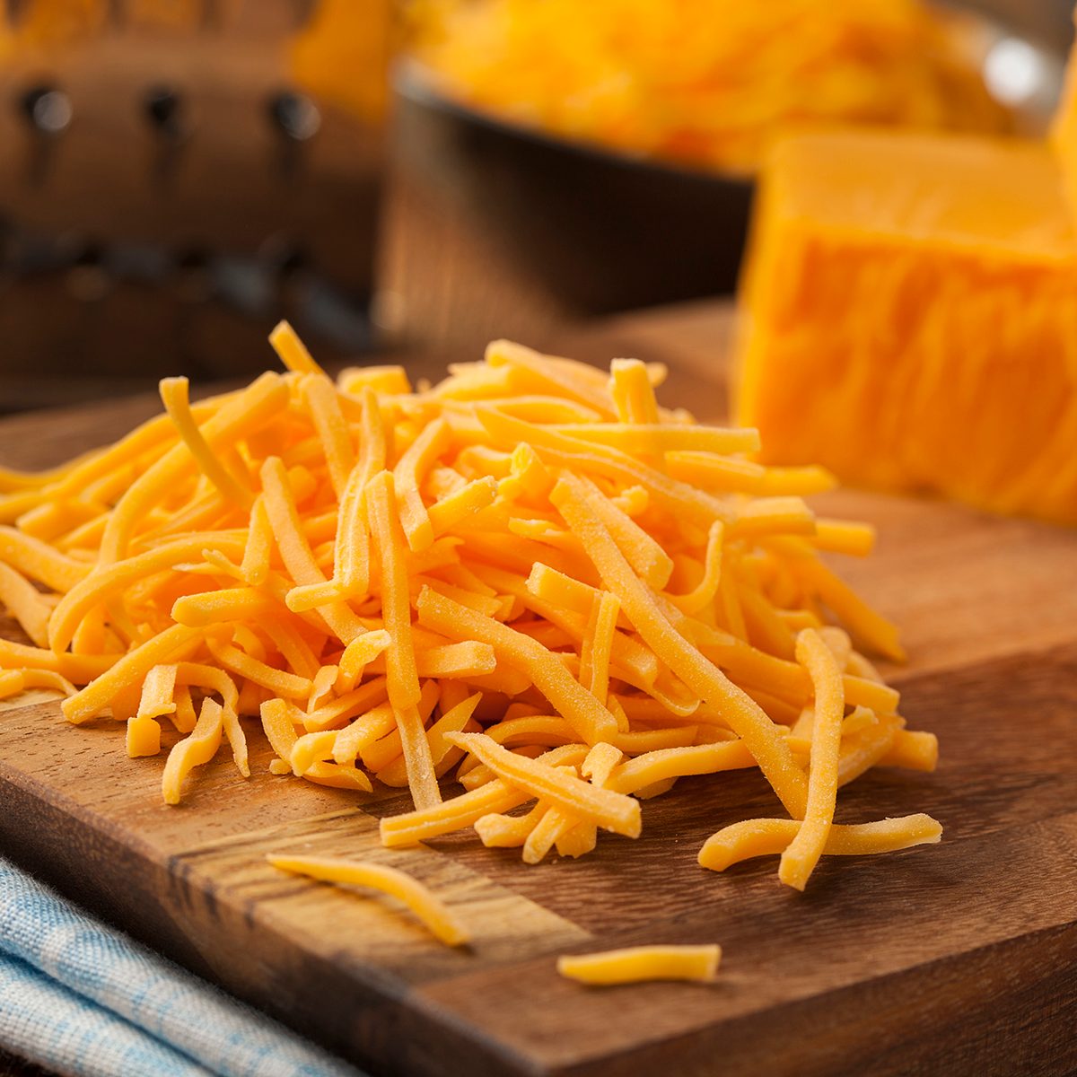 Organic Shredded Sharp Cheddar Cheese on a Cutting Board