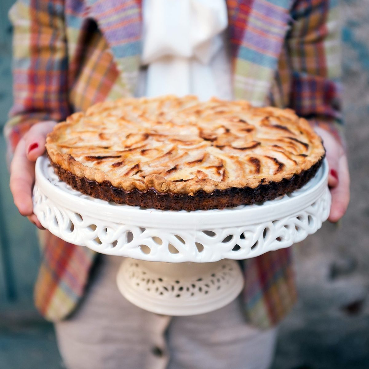 Person holding out a pie