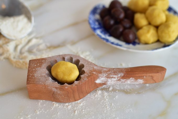 Ma'amoul dough ball in a ma'amoul cookie mold