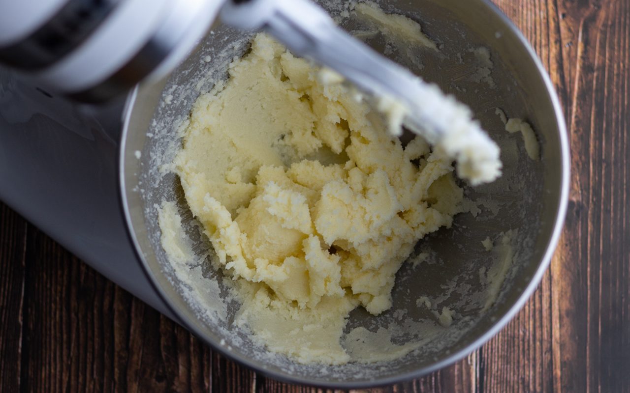 Bowl of stand mixer with blended butter mixture. how to cream butter and sugar