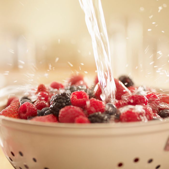 colander uses Water Splashing Over Berries In Colander