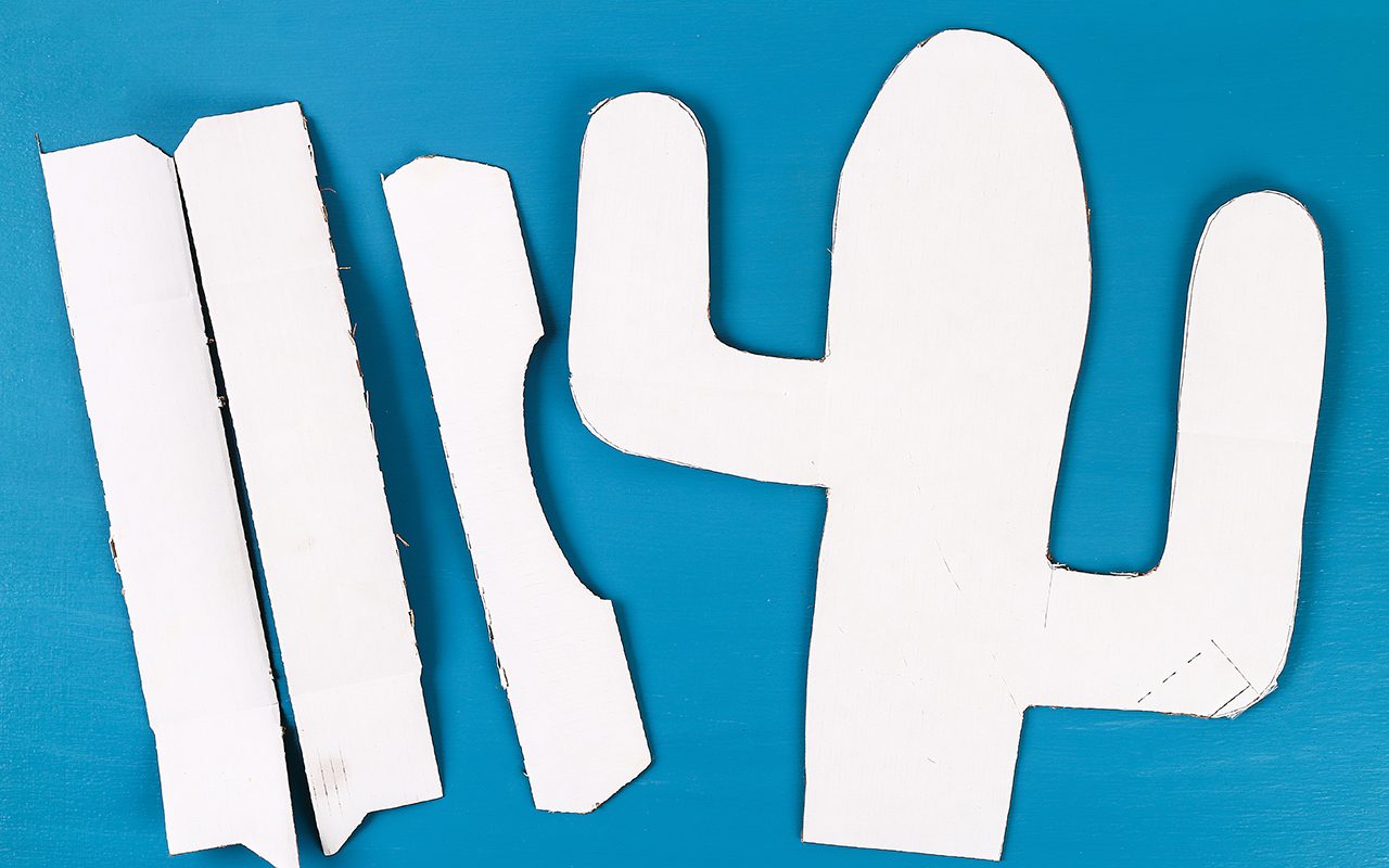 Diy cinco de mayo Mexican Pinata Cactus made cardboard and crepe paper your own hands on a blue background. Gift idea, decor, game cinco de mayo. Step by step. Top view. Process kid children craft.