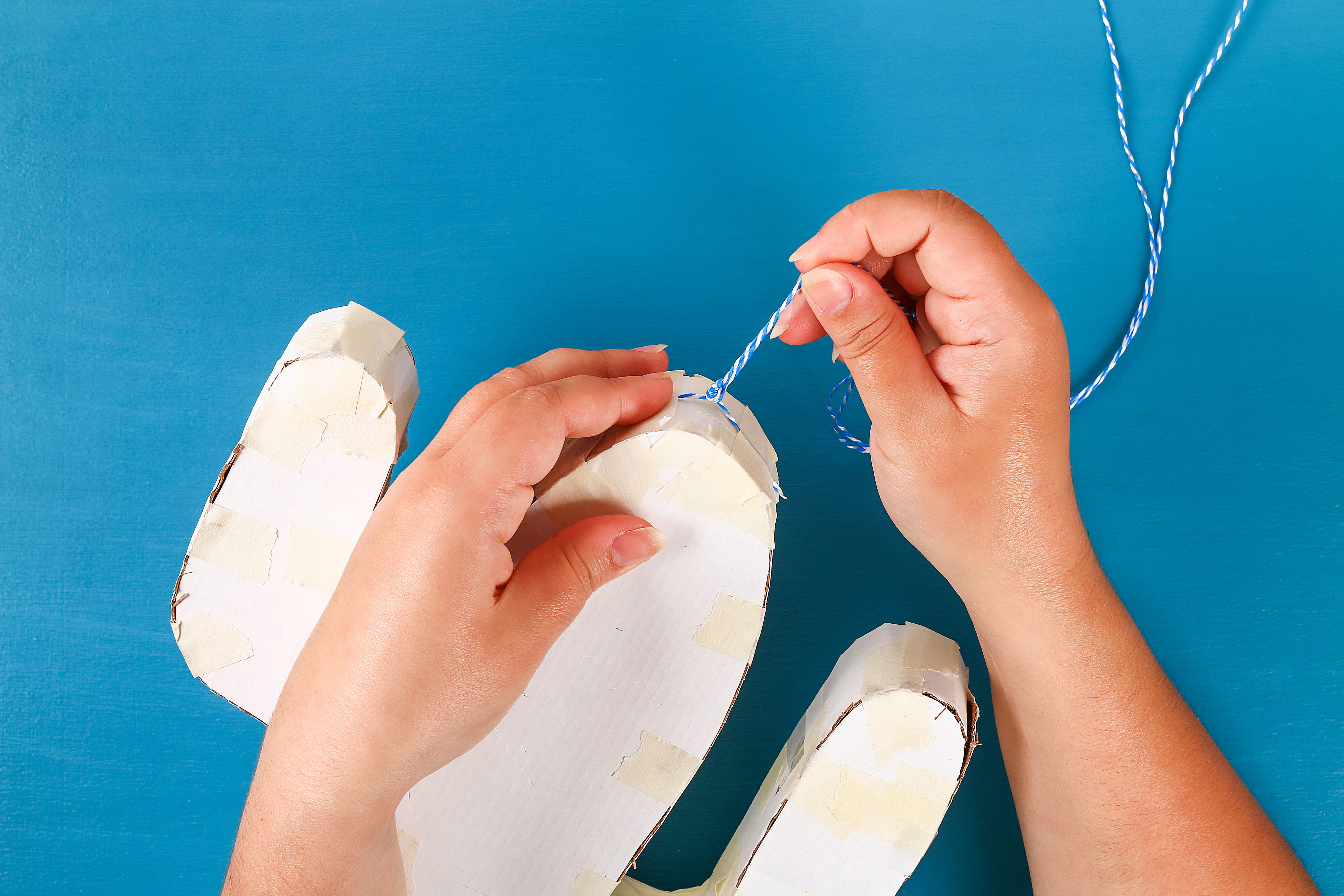 how to make a pinata Diy cinco de mayo Mexican Pinata Cactus made cardboard and crepe paper your own hands on a blue background. Gift idea, decor, game cinco de mayo. Step by step. Top view. Process kid children craft.