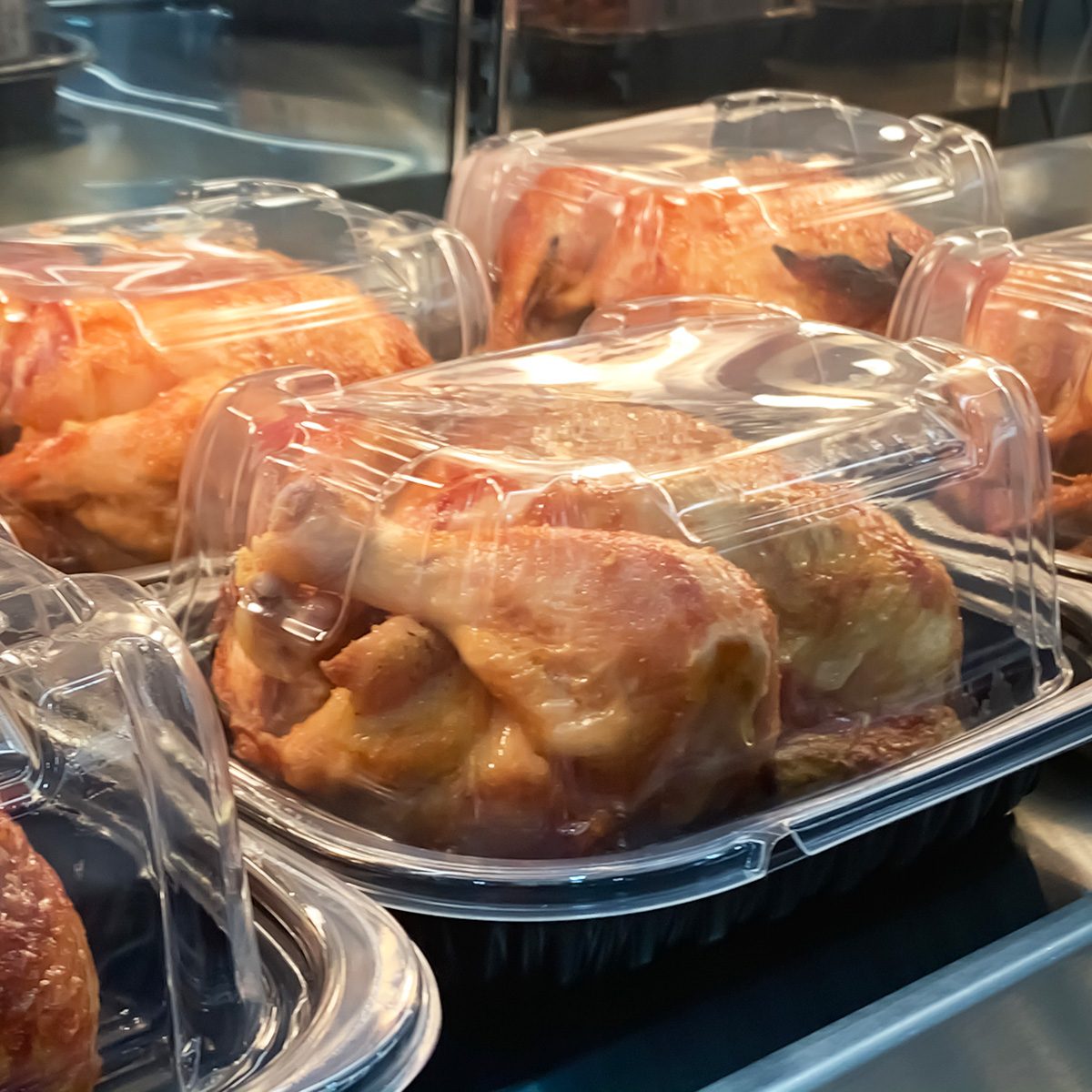 Packed roast chicken place on the shelf waiting to sale in the market deli section