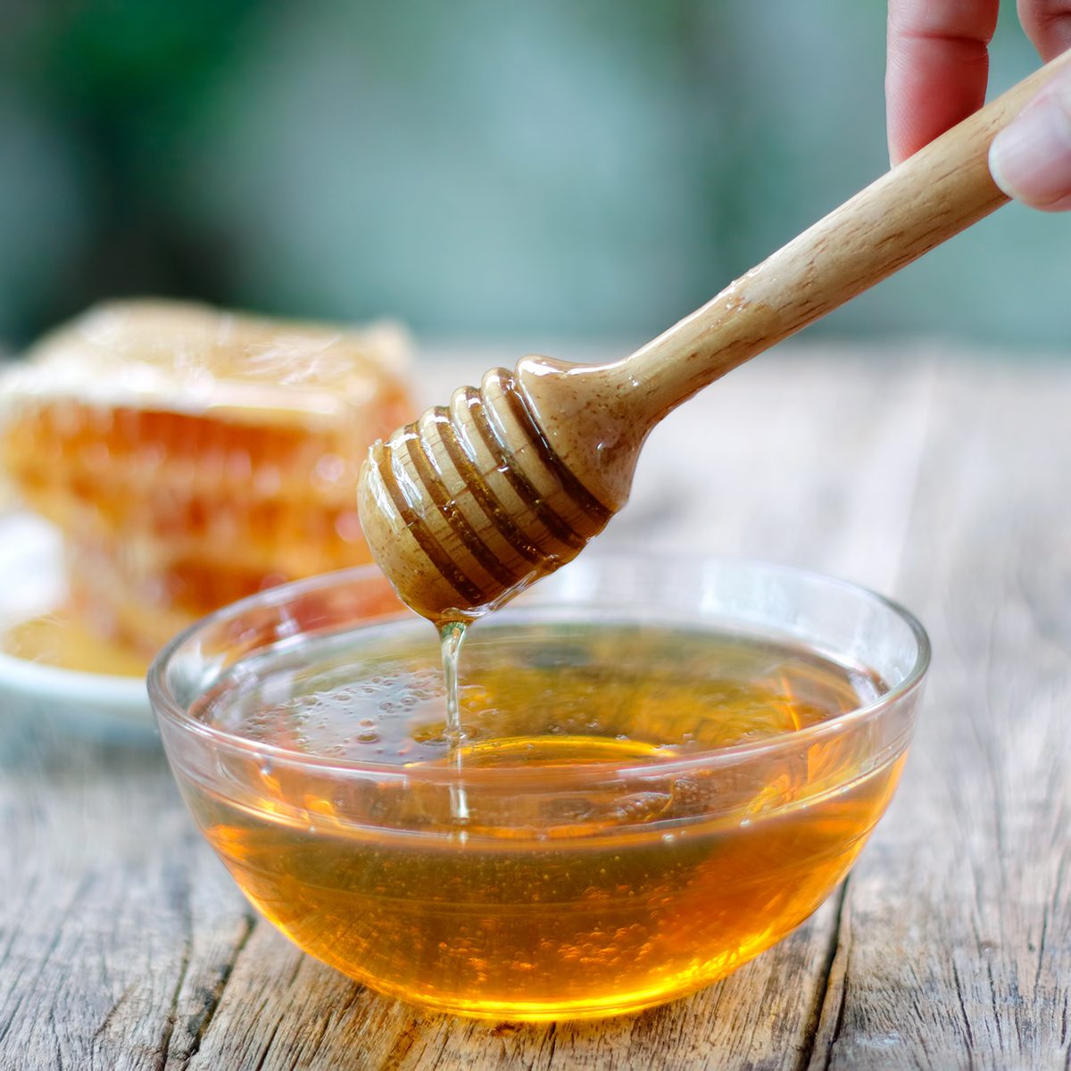 Honey Dipper And Honeycomb On Table