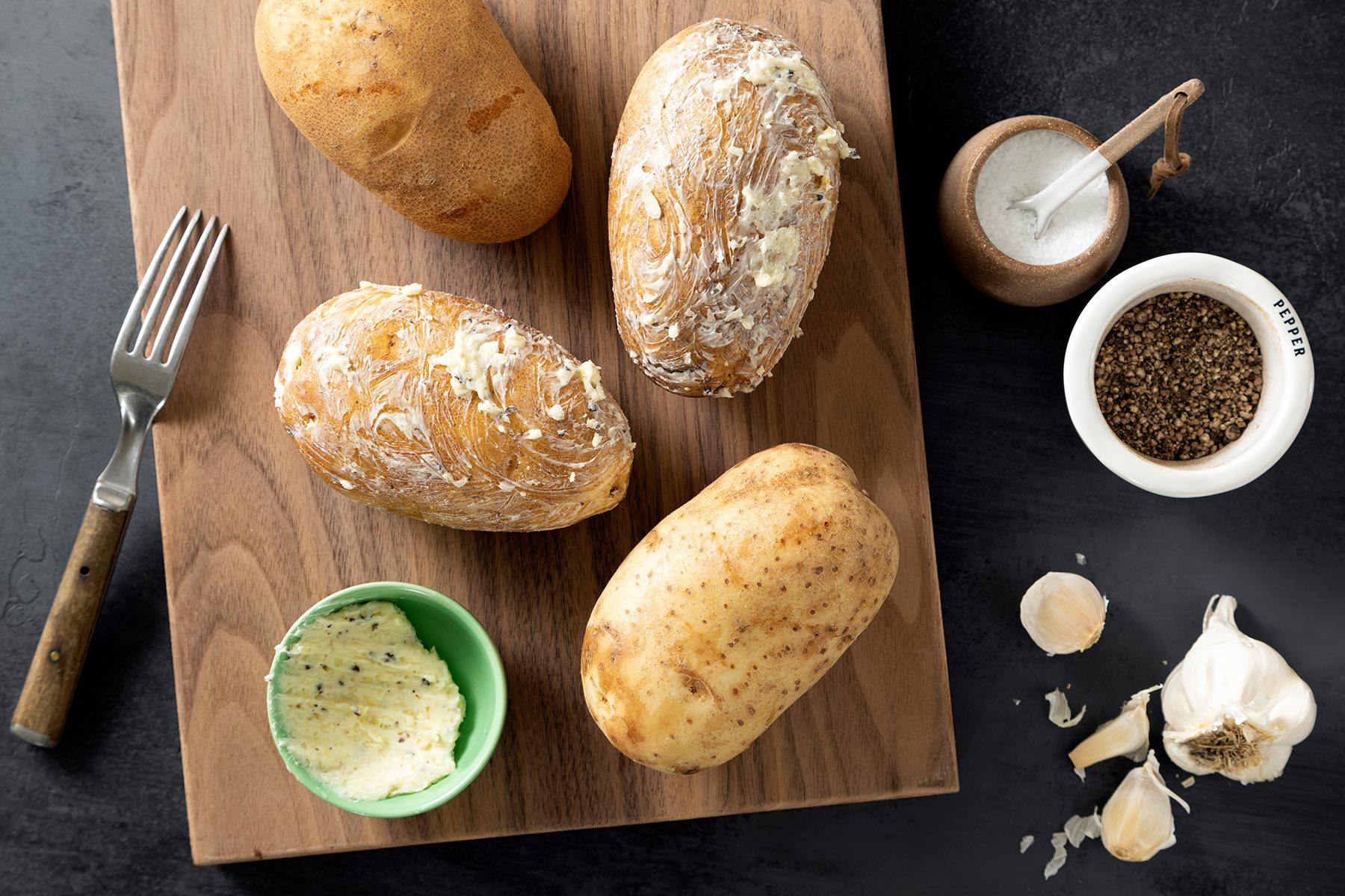 Potatoes with the Butter Mixture on a Cutting Board