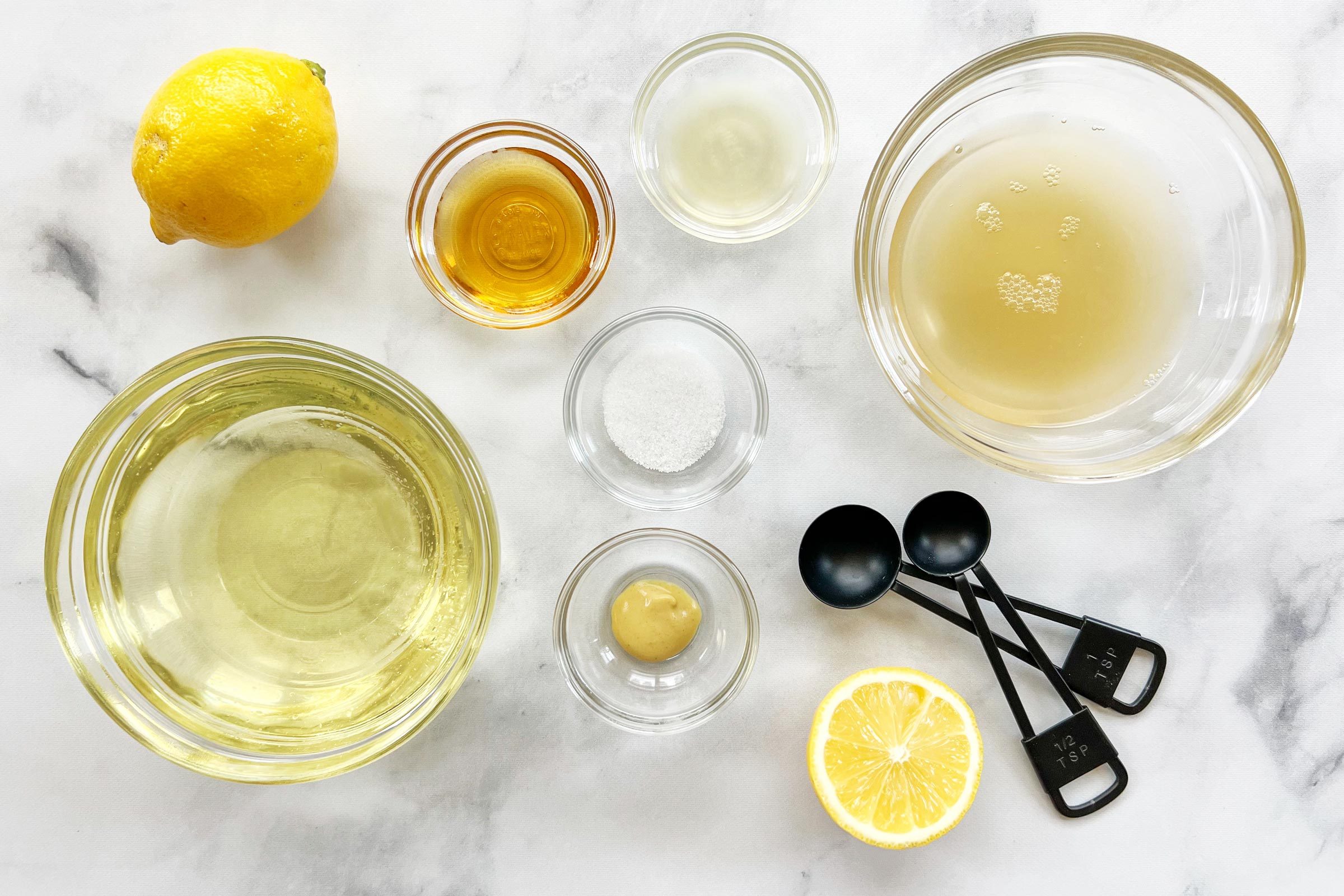 Vegan Mayonnaise Ingredients in small glass bowls on a white marble counter, view from above