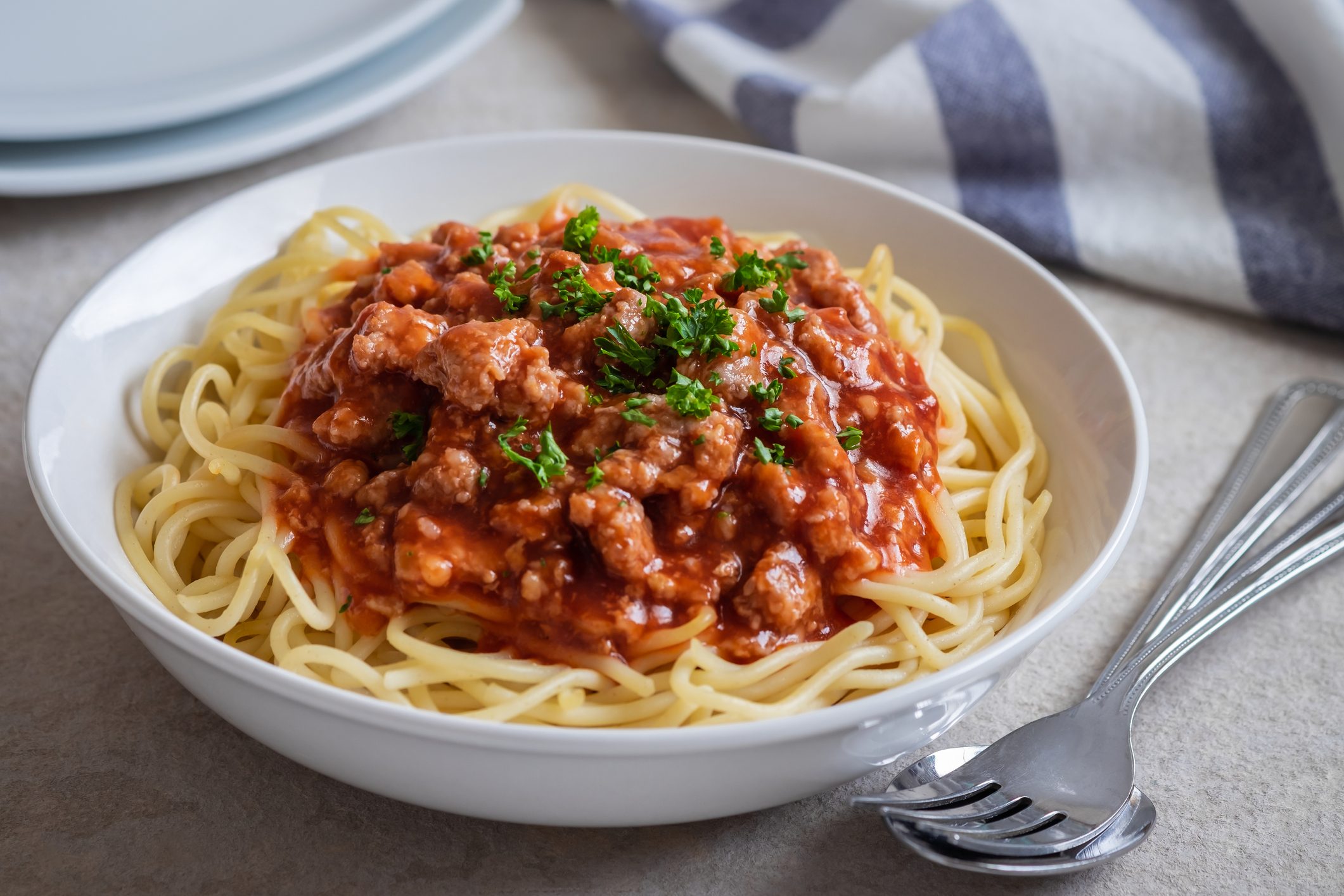 Spaghetti bolognese in white bowl