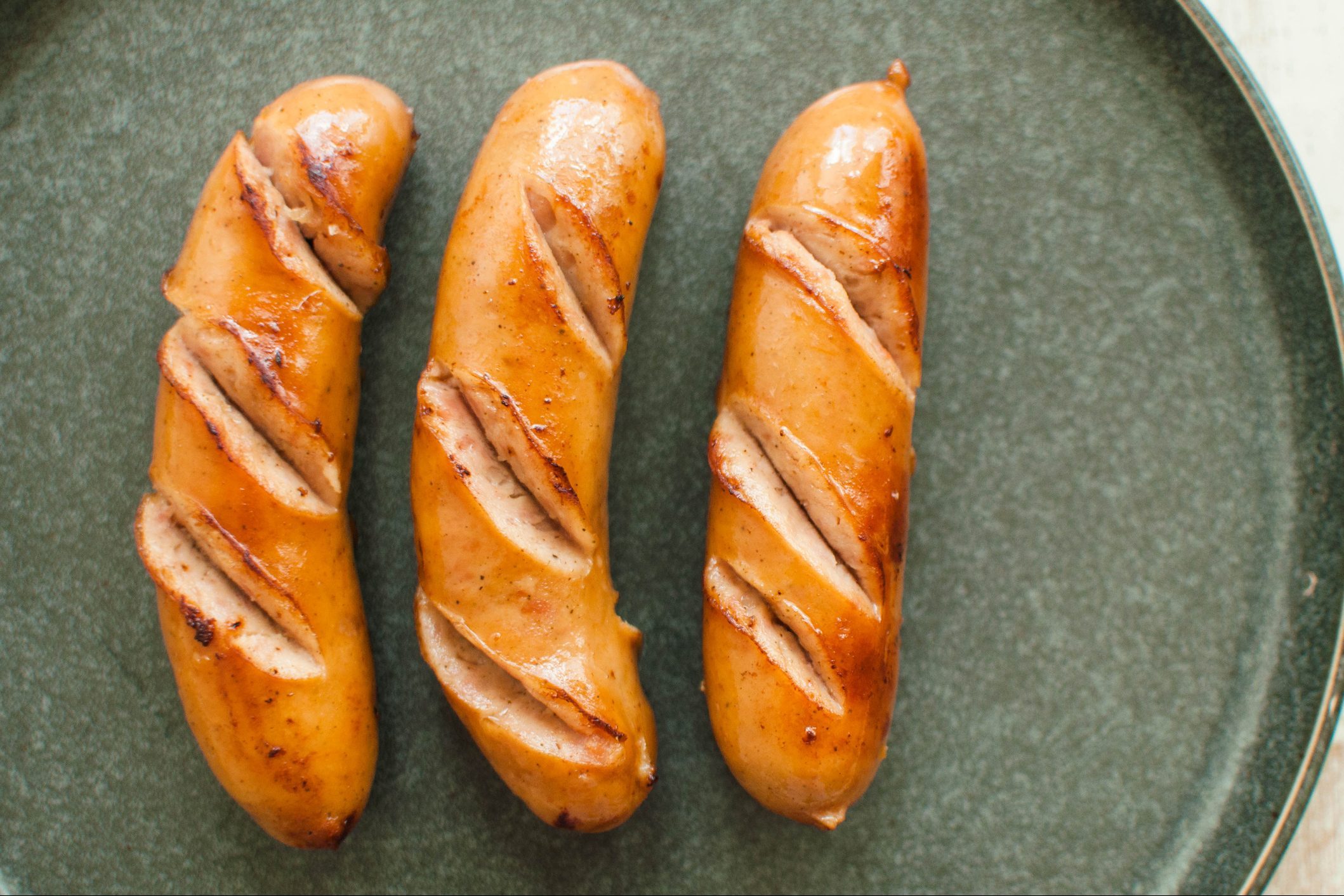 High angle view of bratwurst sausages on a rustic plate