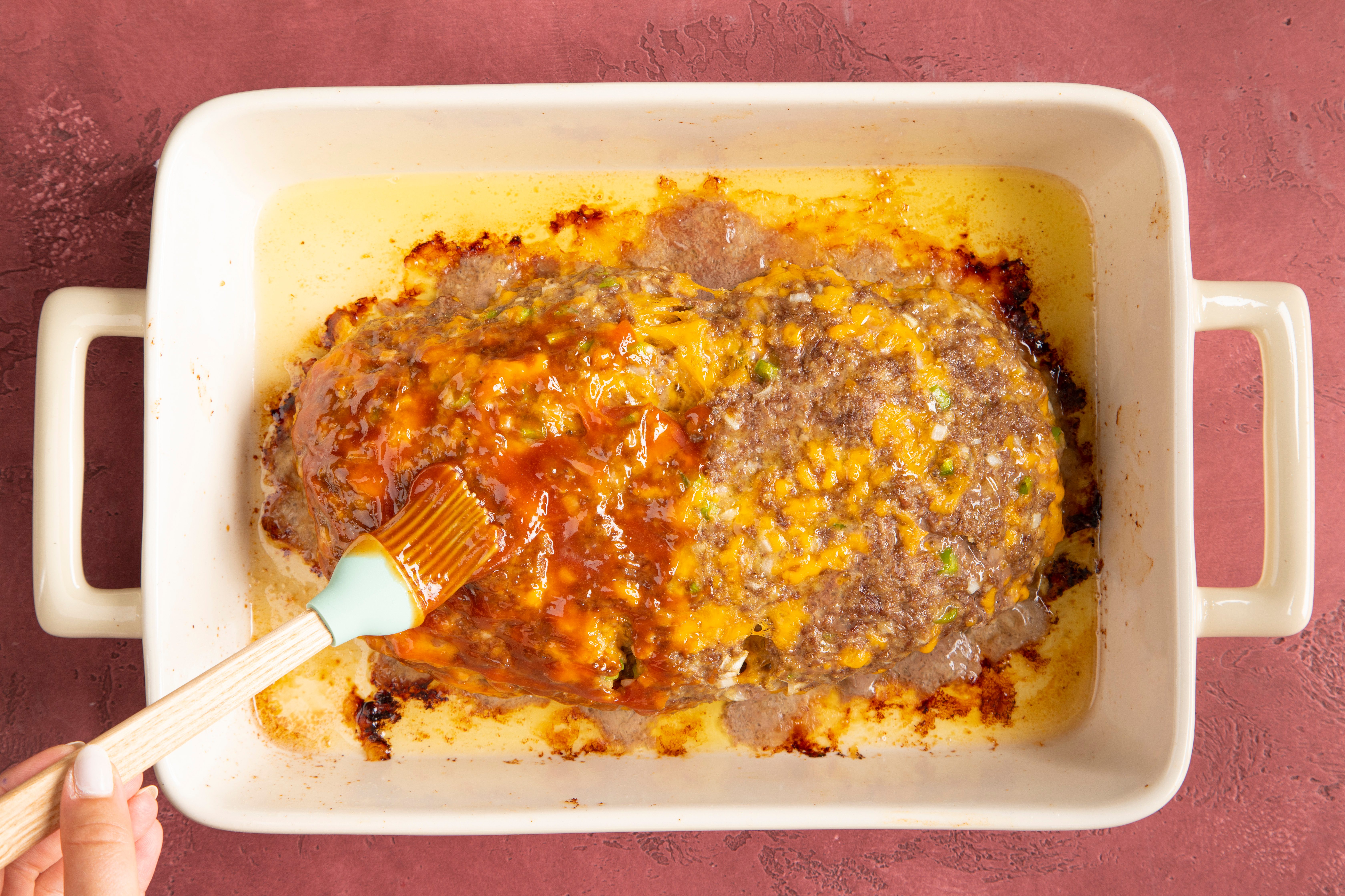 spread sauce on top of copycat meatloaf