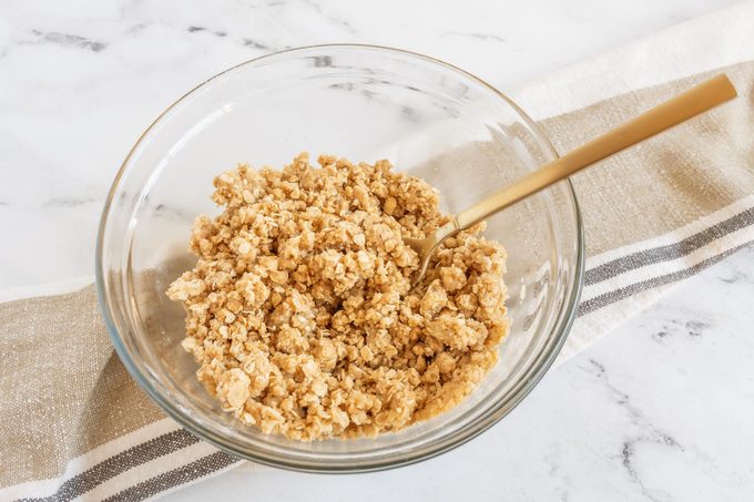 a clear glass bowl with amish apple goodie topping