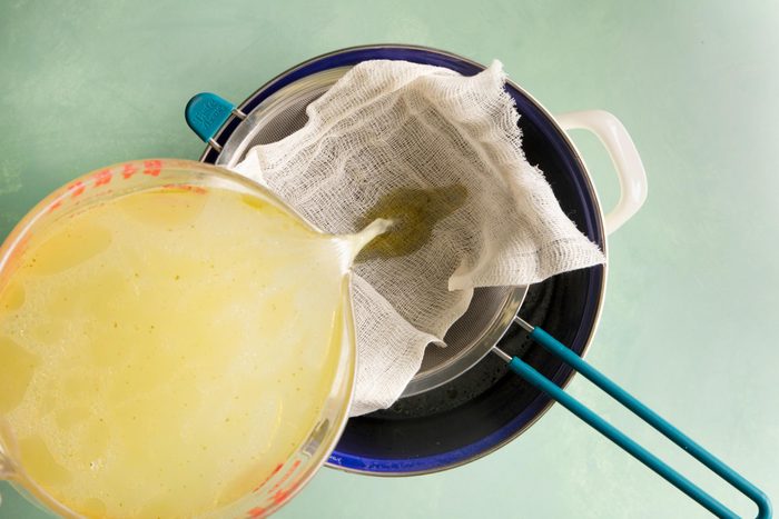 straining broth with cheesecloth