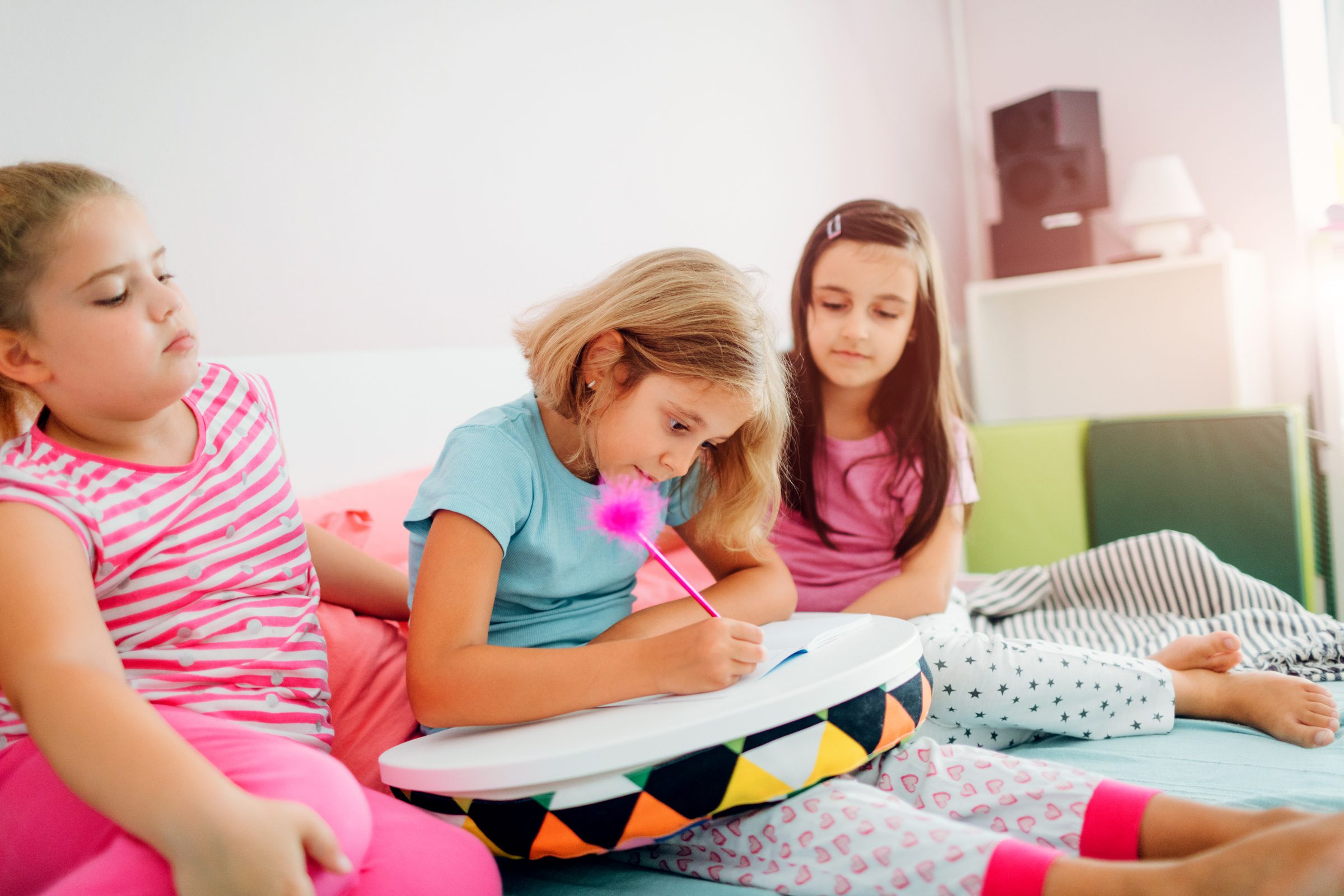girls with a notebook at a sleepover