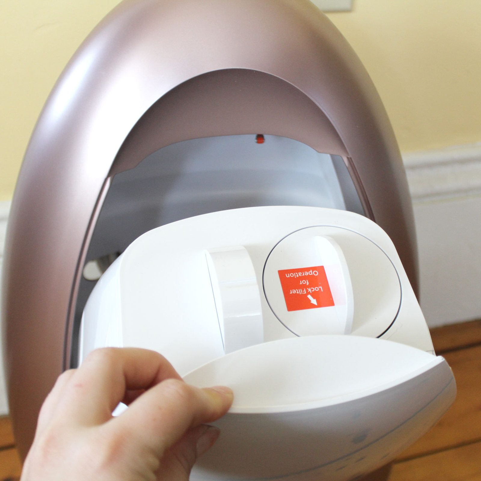 opening an EyeVac to show the dustbin